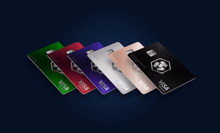 Row of metal crypto payment cards from several issuers, shown as an illustration of the category